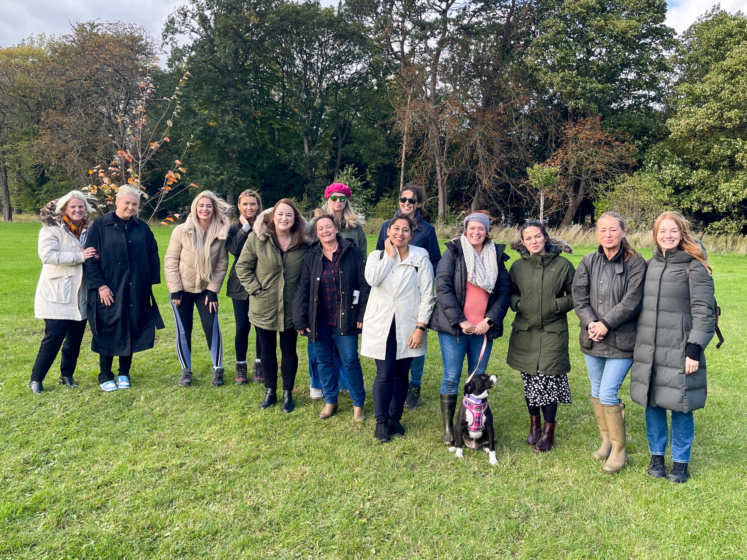 Group of people stood looking towards the camera at the Sisterwood